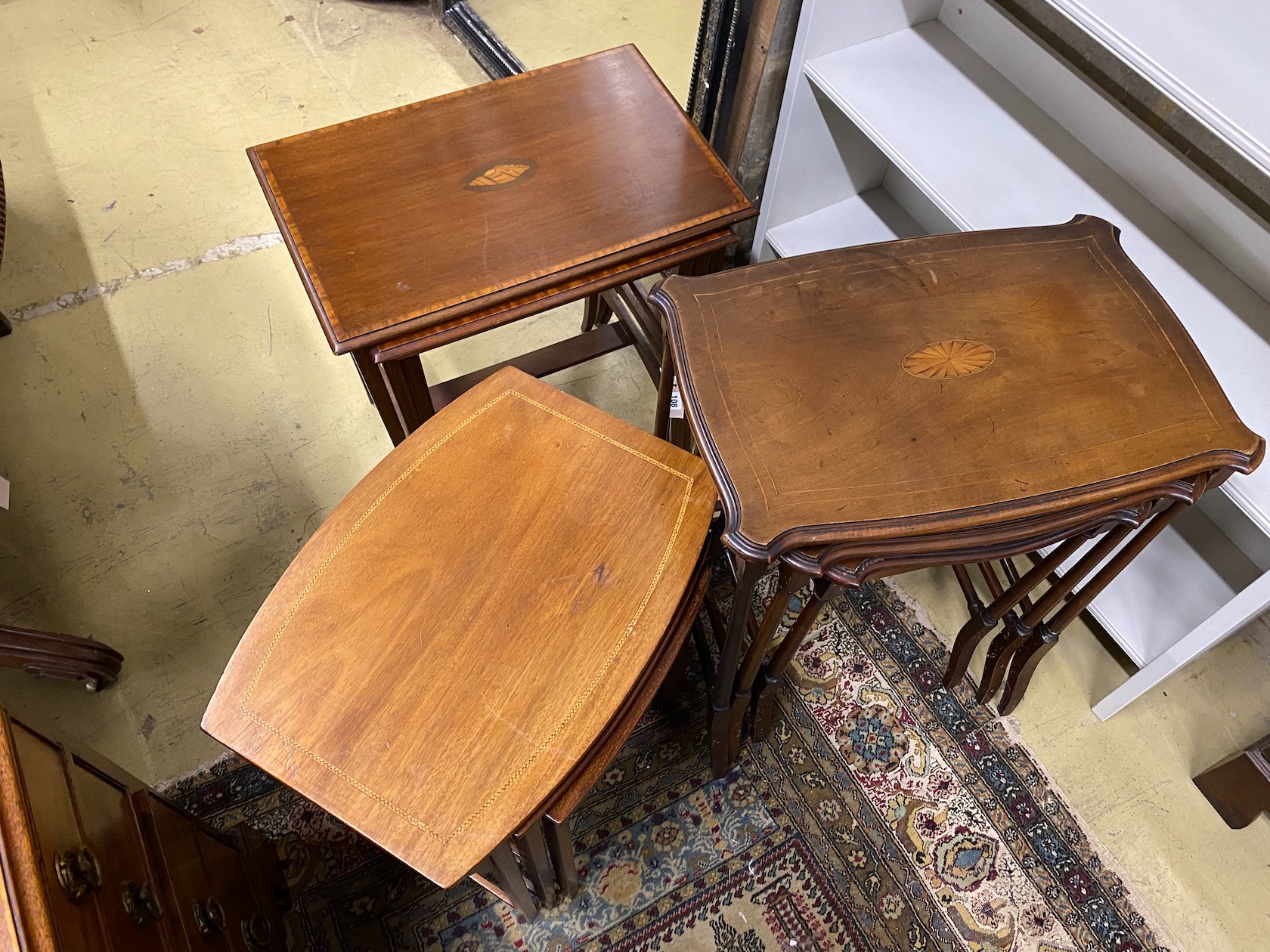 Three nests of Edwardian inlaid mahogany tea tables, largest width 56cm, depth 38cm, height 57cm